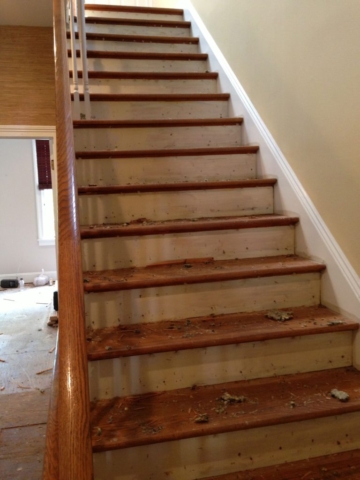 A photo a hardwood stair treads prior to refinishing.