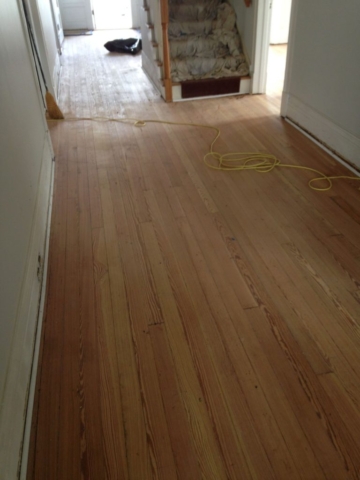 A picture of completely sanded hardwood previously covered in tar.