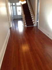 Satin finished, smooth, red toned, hardwood floors that were previous cover with tar and tile.