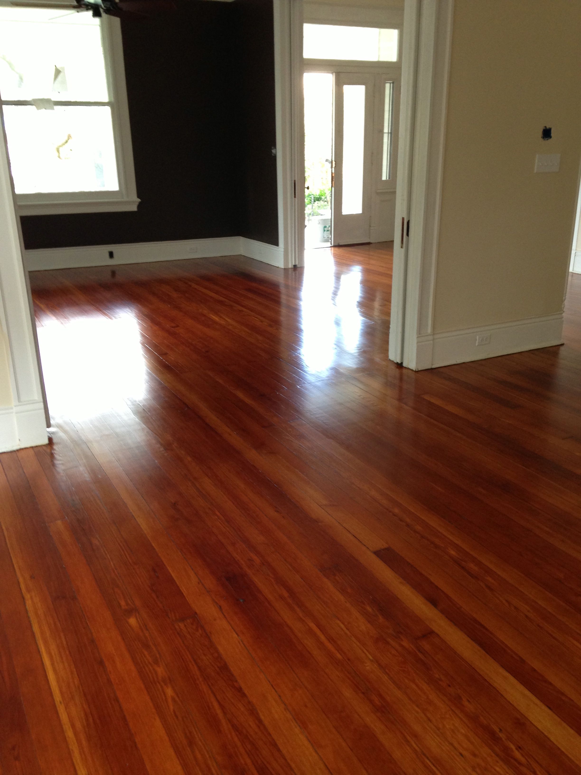Shiny refinished hardwood flooring in front room and living area.
