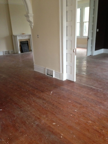 Hardwood floors in living areas prior to being refinished.