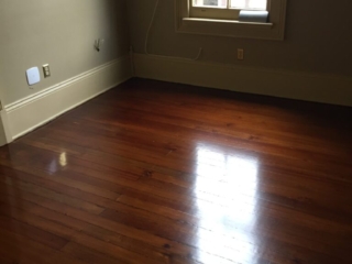 This is a bedroom of refinished hardwood pine floors.