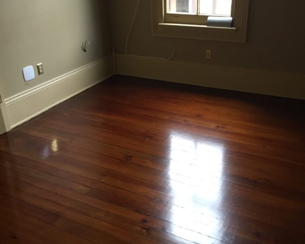 This is a bedroom of refinished hardwood pine floors.
