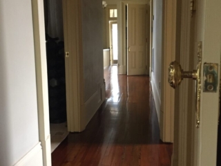 This is a hallway of refinished hardwood pine floors.