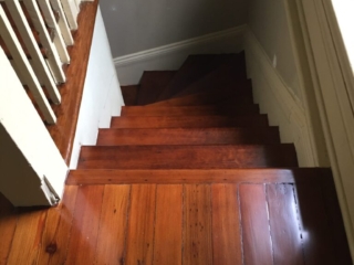 This is a staircase of refinished hardwood pine floors.