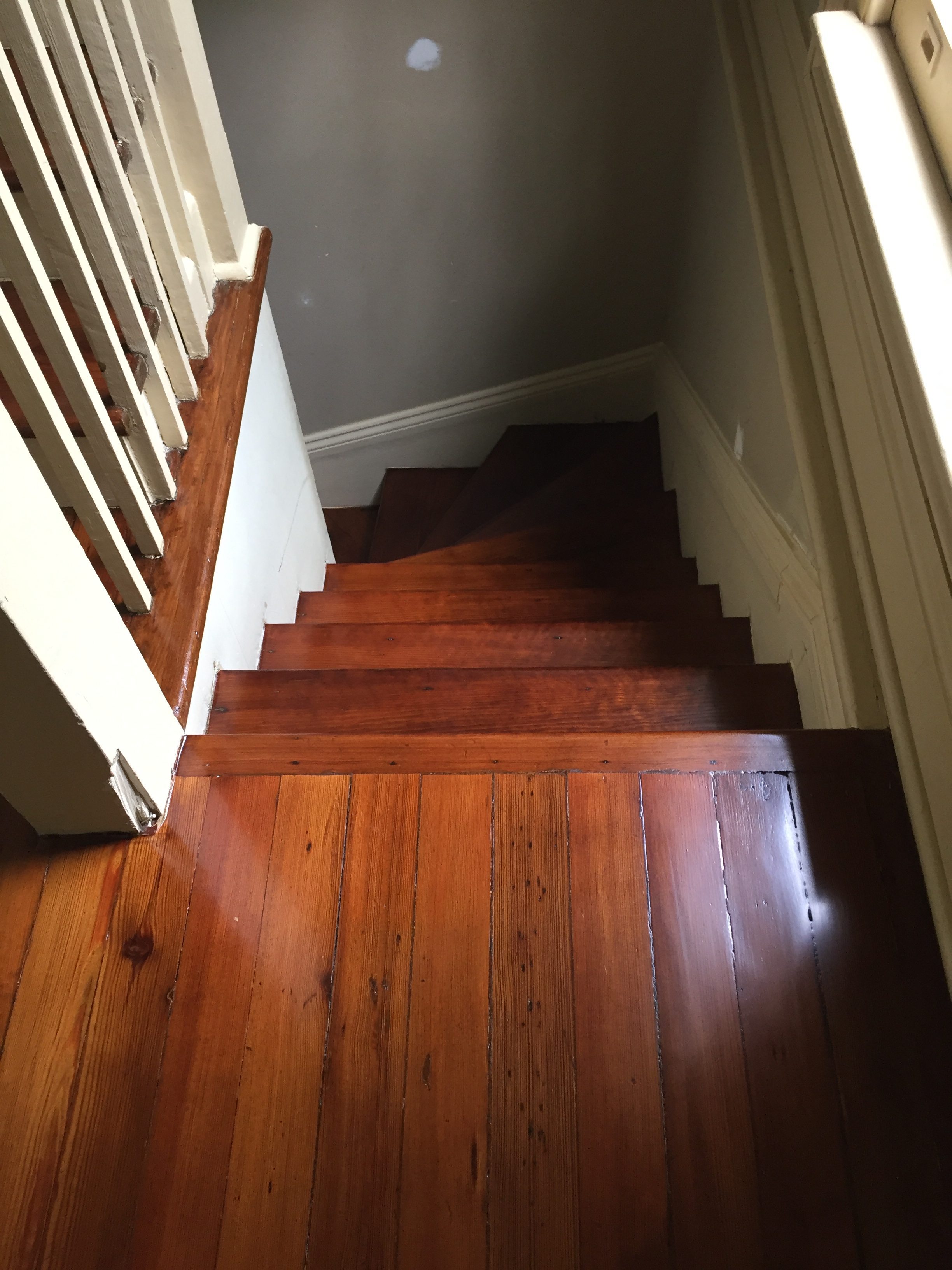 This is a staircase of refinished hardwood pine floors.