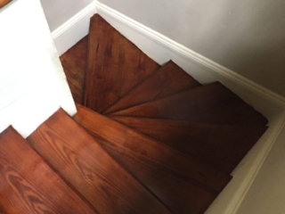 This is a staircase of refinished hardwood pine floors.