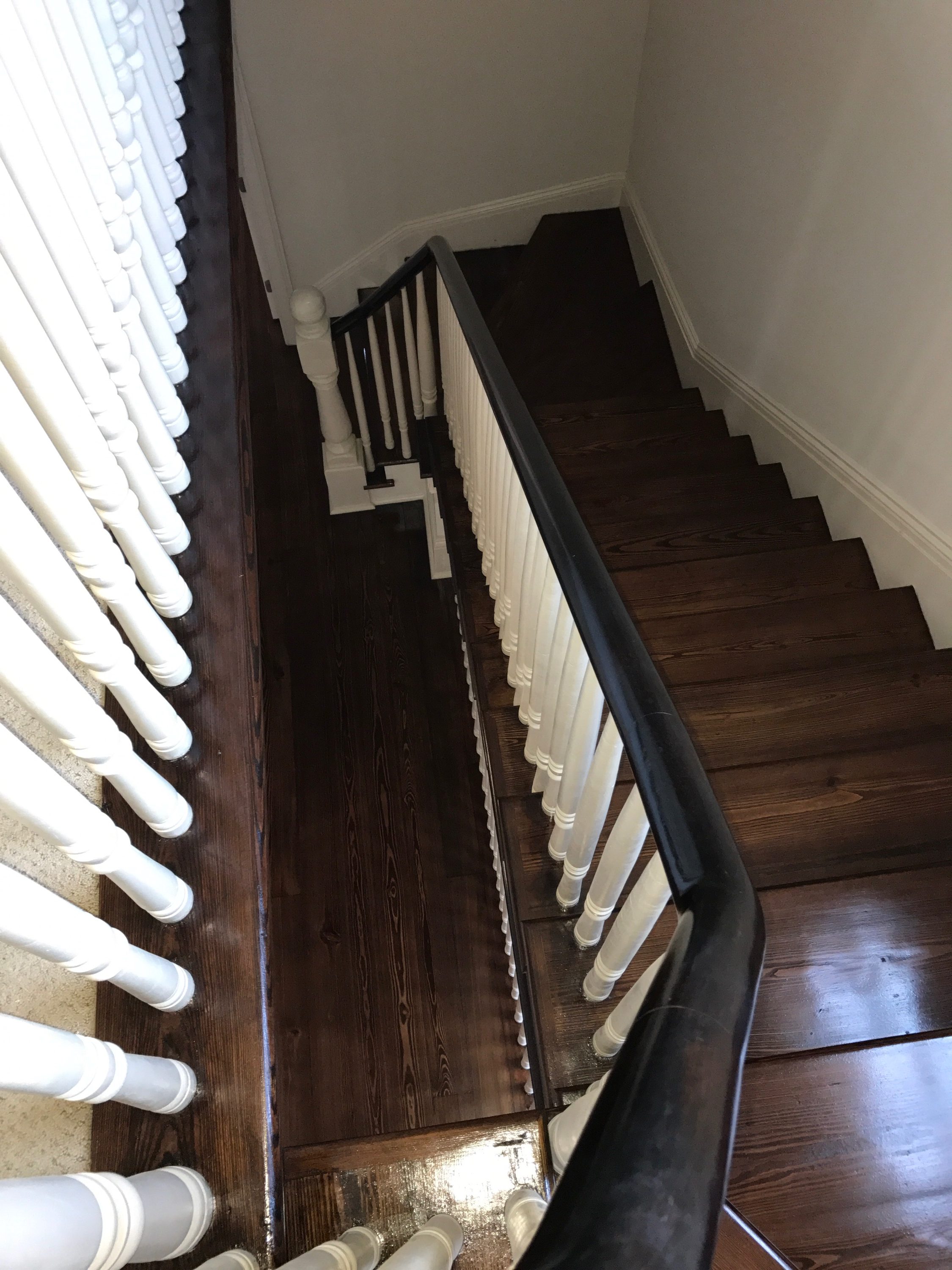 This is a dark stained red pine staircase with a landing.