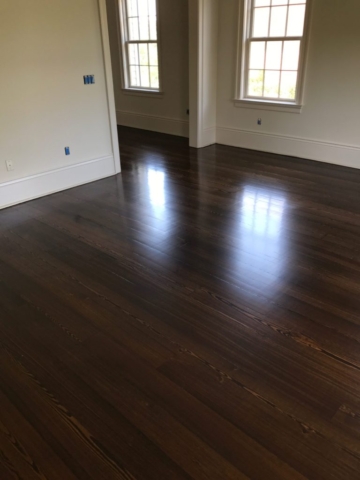 Pictured is a room with dark stained red pine hardwood flooring.