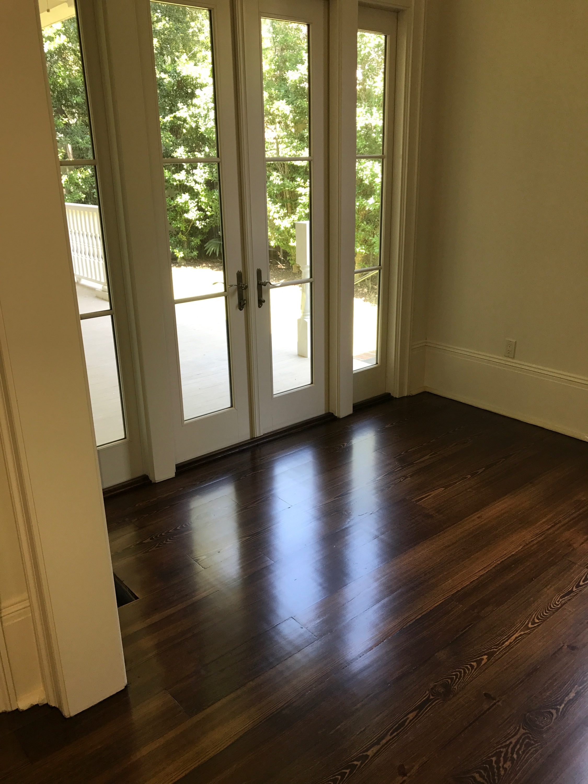 Pictured is a room with dark stained red pine hardwood flooring.