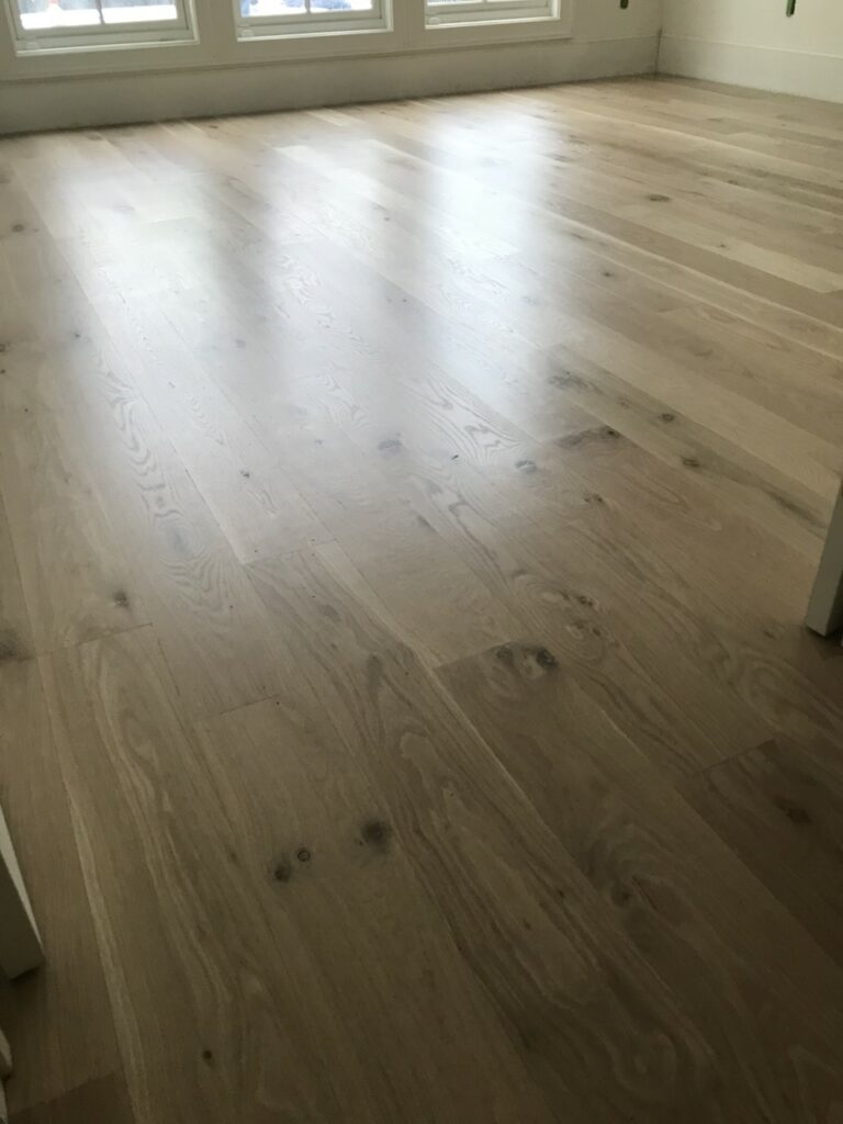 This is a photo of a front room with white oak flooring with a satin finish. It has a weather washed appearance.