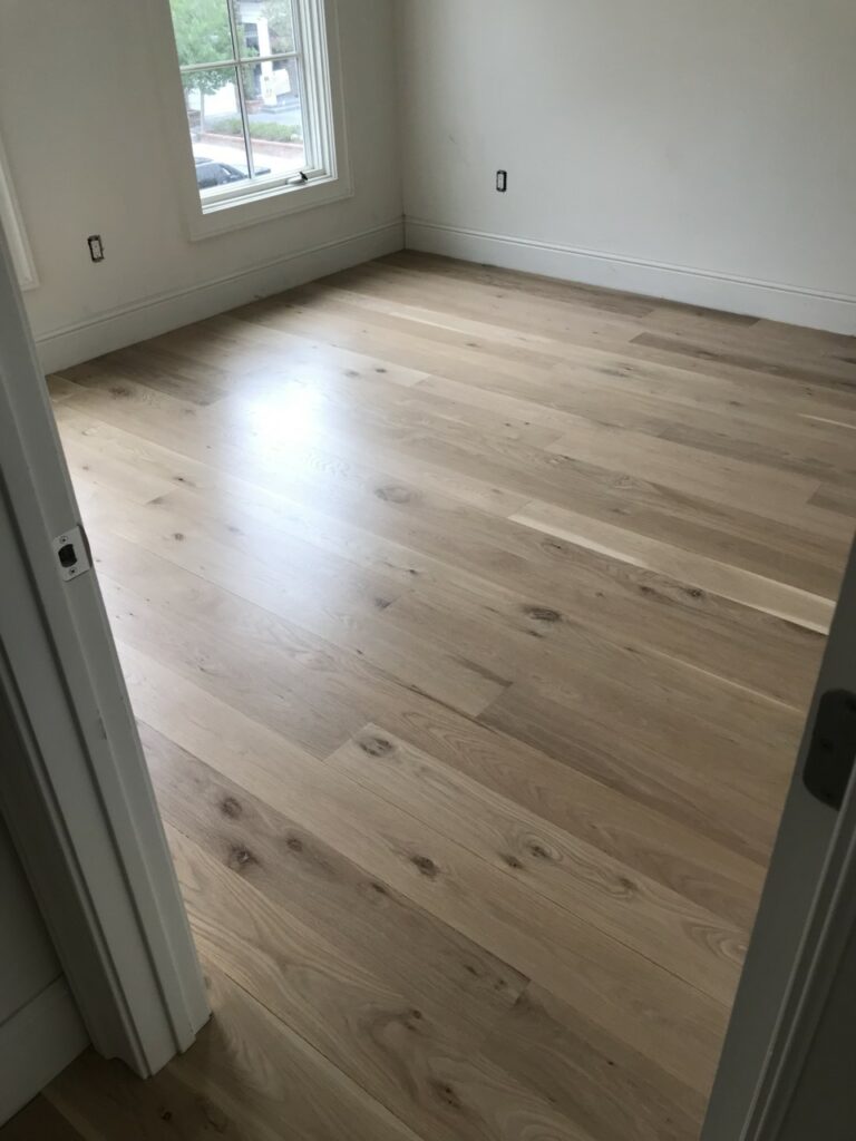 This is a photo of a room with white oak flooring with a satin finish. It has a weather washed appearance.