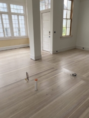 After bleached with a white wash finish, a living area with a column and white walls