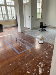 Before photo in living area with a column and red heart of pine hardwood floors