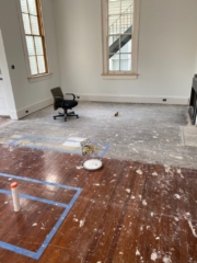 Before shot of den area with red heart of pine flooring prior to bleaching with a white wash