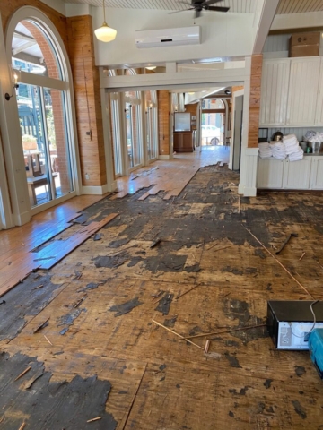 Existing hardwood flooring in a restaurant in the process of removal to be replaced with new hardwood flooring.