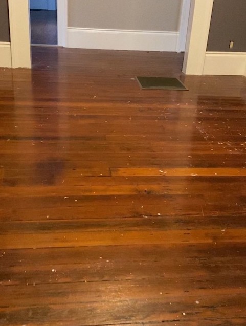 wooden flooring needing some TLC and a metal floor grill