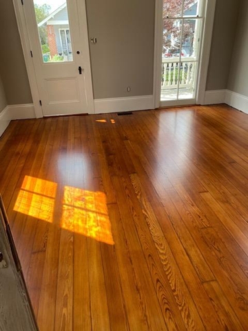 Refinished Red Heart of Pine Hardwood Flooring with an entry door and window