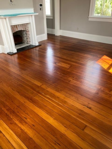 Refinished Red Heart of Pine Hardwood Flooring with a fireplace in the room