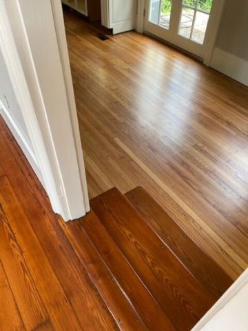 Refinished Red Heart of Pine and Red Oak Hardwood Flooring joined at split level with refinished red heart of pine stairs