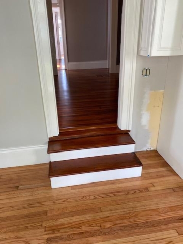 Refinished Red Heart of Pine and Red Oak Hardwood Flooring joined by red heart of pine stairs dropping into the split level